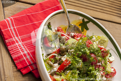 Image of Bowl of Marinated Greek Salad with Red Napkin