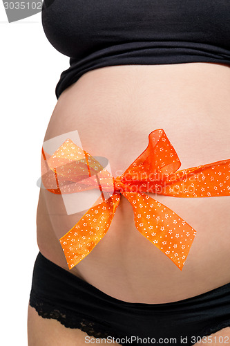 Image of Pregnant woman wearing a bow on her belly
