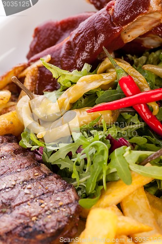 Image of Platter of mixed meats, salad and French fries