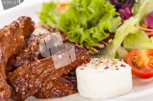 Image of grilled beef stripes fresh salad and goat cheese