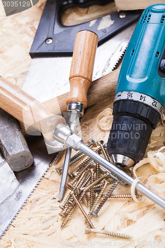 Image of Drill with timber, screwdrivers and screws