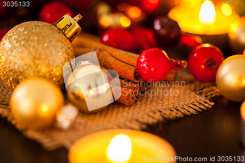 Image of Warm gold and red Christmas candlelight background