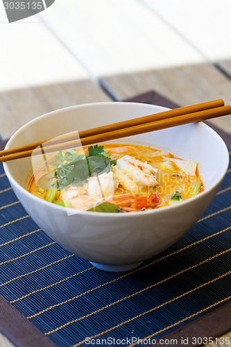 Image of Bowl of traditional Thai tom yam soup