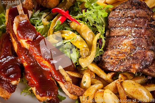 Image of Platter of mixed meats, salad and French fries