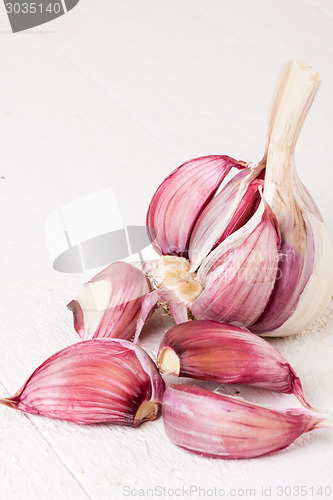 Image of Fresh garlic bulb with loose cloves