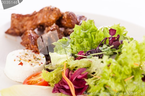 Image of grilled beef stripes fresh salad and goat cheese