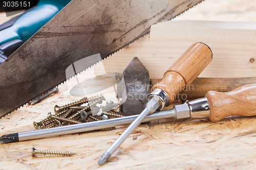 Image of Drill with timber, screwdrivers and screws