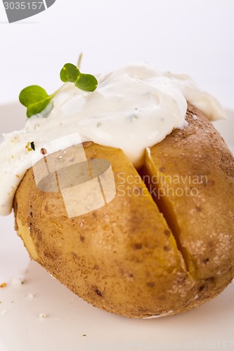 Image of Baked jacket potato with sour cream sauce