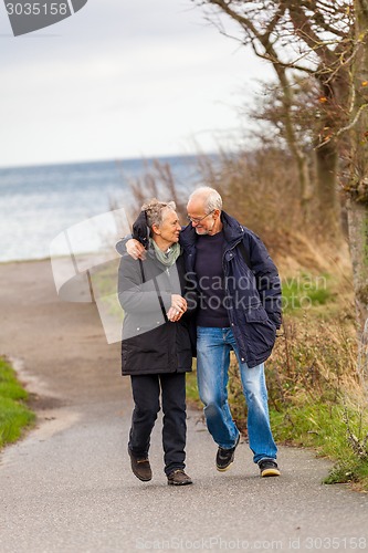 Image of happy mature couple relaxing baltic sea dunes 