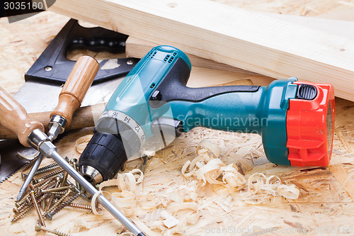 Image of Drill with timber, screwdrivers and screws