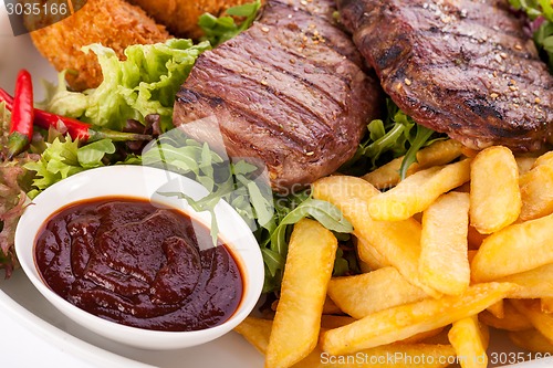 Image of Platter of mixed meats, salad and French fries