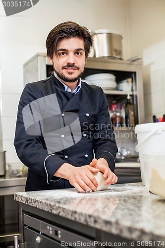 Image of Chef tossing dough while making pastries