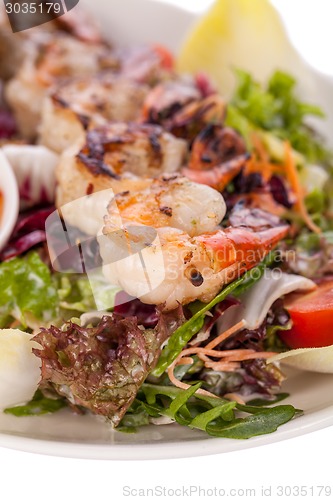 Image of Grilled prawns with endive salad and jacket potato