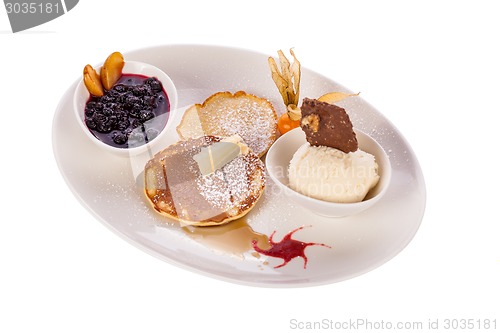 Image of tasty sweet pancakes with vanilla icecream and topping