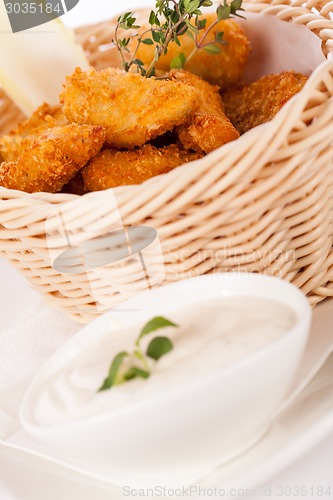 Image of Crumbed chicken nuggets in a basket