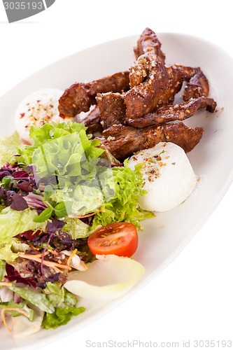 Image of grilled beef stripes fresh salad and goat cheese