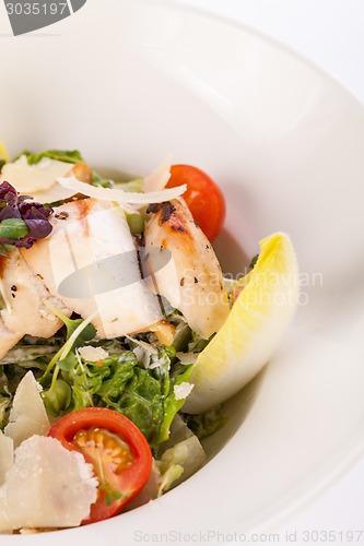 Image of tasty fresh caesar salad with grilled chicken and parmesan 