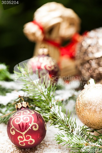 Image of Gold Christmas ornament on leaves