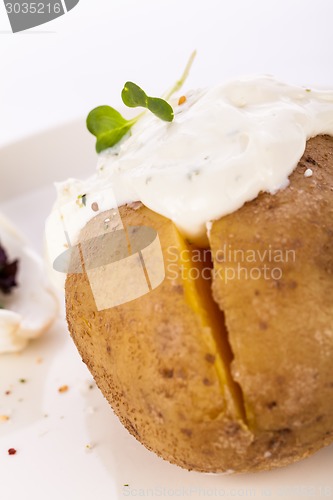 Image of Baked jacket potato with sour cream sauce