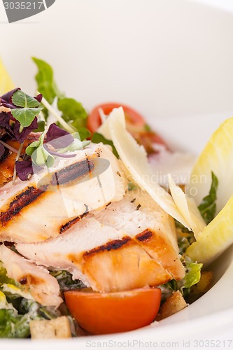 Image of tasty fresh caesar salad with grilled chicken and parmesan 