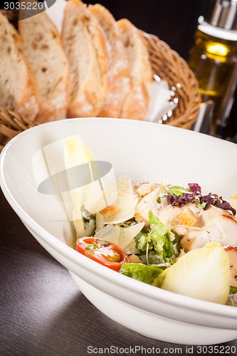 Image of tasty fresh caesar salad with grilled chicken and parmesan 