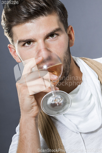 Image of Sexy handsome man drinking white wine