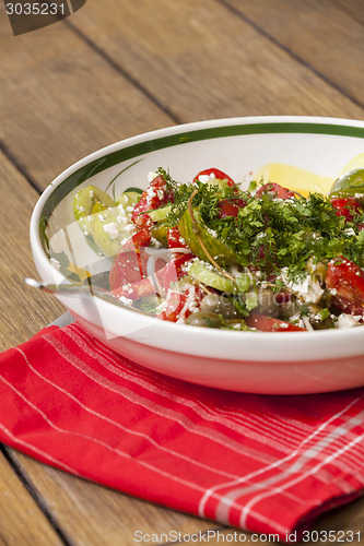 Image of Bowl of Marinated Greek Salad with Red Napkin