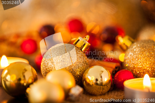 Image of Warm gold and red Christmas candlelight background