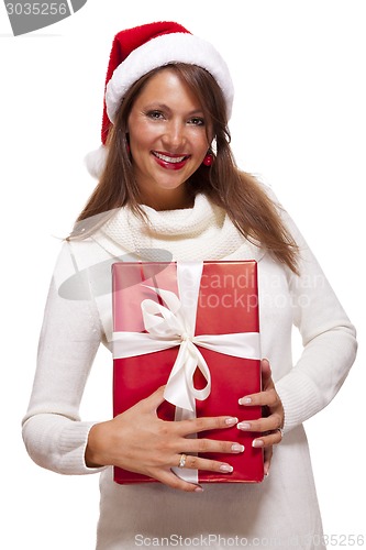 Image of Pretty woman in a Santa hat with a large gift