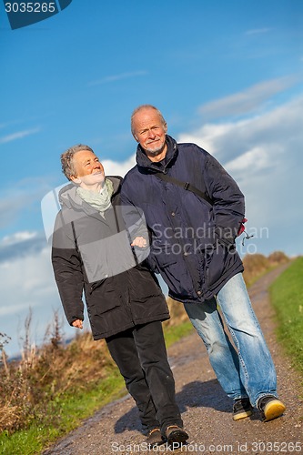 Image of happy mature couple relaxing baltic sea dunes 