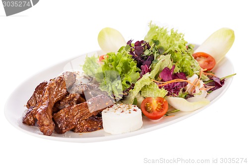 Image of grilled beef stripes fresh salad and goat cheese