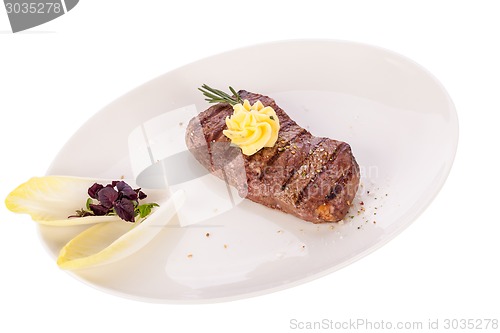 Image of Grilled beef steak topped with butter and rosemary