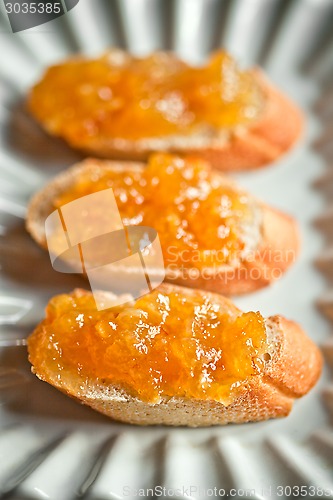 Image of pieces of baguette with orange marmalade