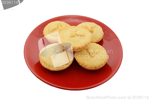 Image of Five homemade mince pies on a festive red plate