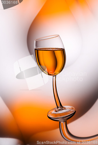 Image of Glass of whiskey matured in reflections.