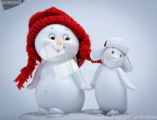 Image of Cheerful snowman and penguin