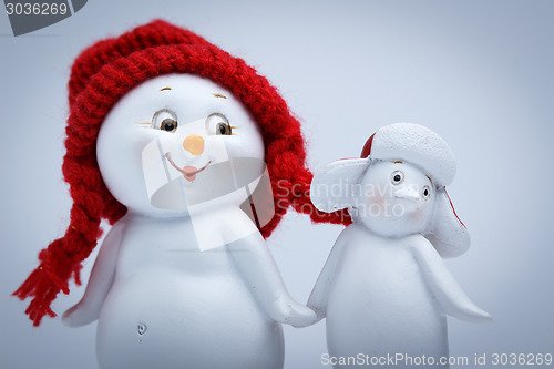 Image of Cheerful snowman and penguin