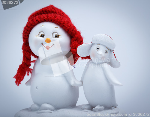 Image of Cheerful snowman and penguin