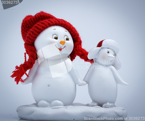 Image of Cheerful snowman and penguin