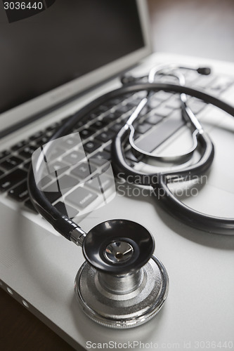 Image of Medical Stethoscope Resting on Laptop Computer