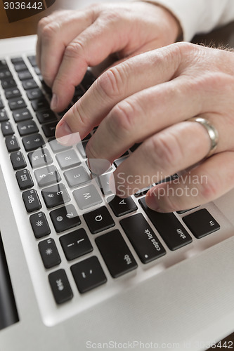 Image of Male Hands Typing on Laptop Computer