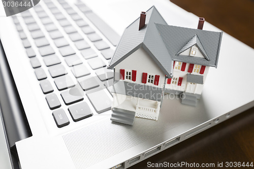 Image of Miniature House on Laptop Computer
