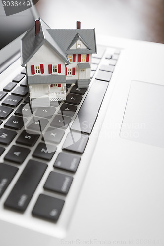 Image of Miniature House on Laptop Computer