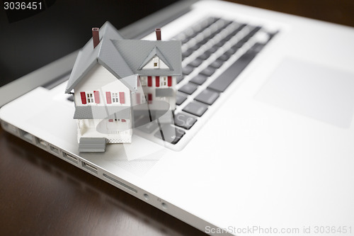 Image of Miniature House on Laptop Computer