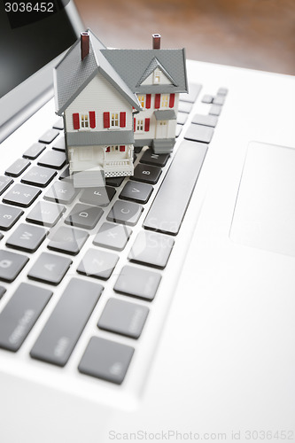 Image of Miniature House on Laptop Computer