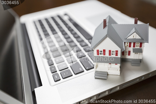 Image of Miniature House on Laptop Computer