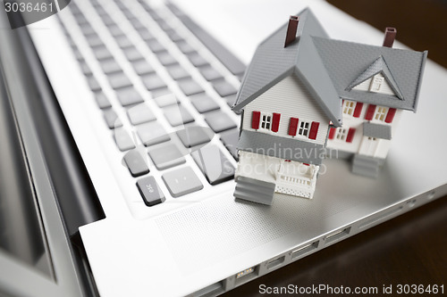 Image of Miniature House on Laptop Computer