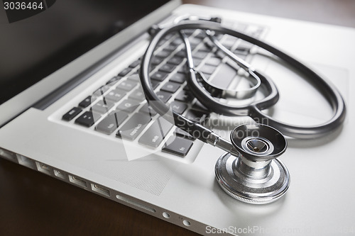 Image of Medical Stethoscope Resting on Laptop Computer