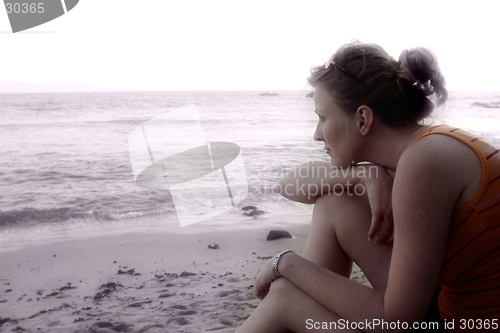 Image of Woman sitting on the beach