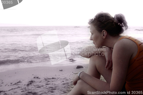 Image of Woman sitting on the beach